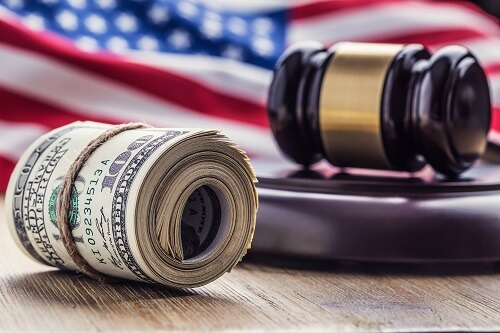 us flag with judges hammer and dollar bills