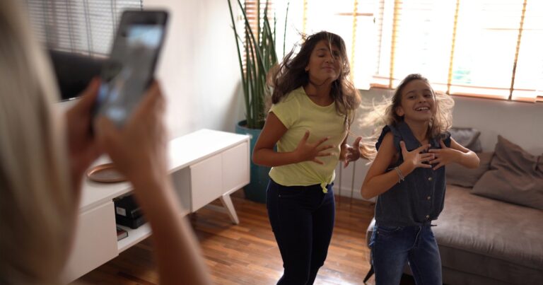 mother filming teenager daughters