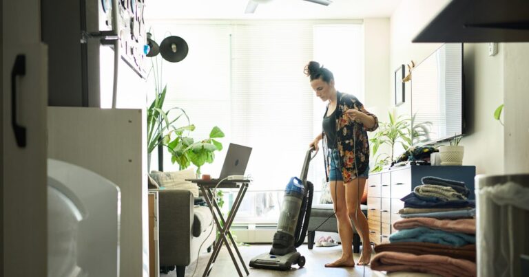 young woman vacuuming her